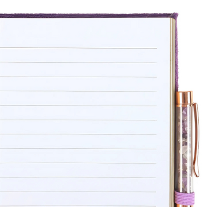 An open Book of Spells Journal showing lined pages, a crystal-infused pen, and a pen holder, ideal for journaling, affirmations, or spellwork.