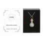 A Green Aventurine crystal chip bottle necklace in a celestial-inspired gift box, symbolizing luck, prosperity, and abundance.