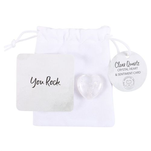 The image shows a small gift set that includes a white drawstring bag, a clear quartz heart-shaped crystal, a square card with the message "You Rock," and a round tag that reads "Clear Quartz Crystal Heart & Sentiment Card." The set appears to be a thoughtful and motivational gift item.